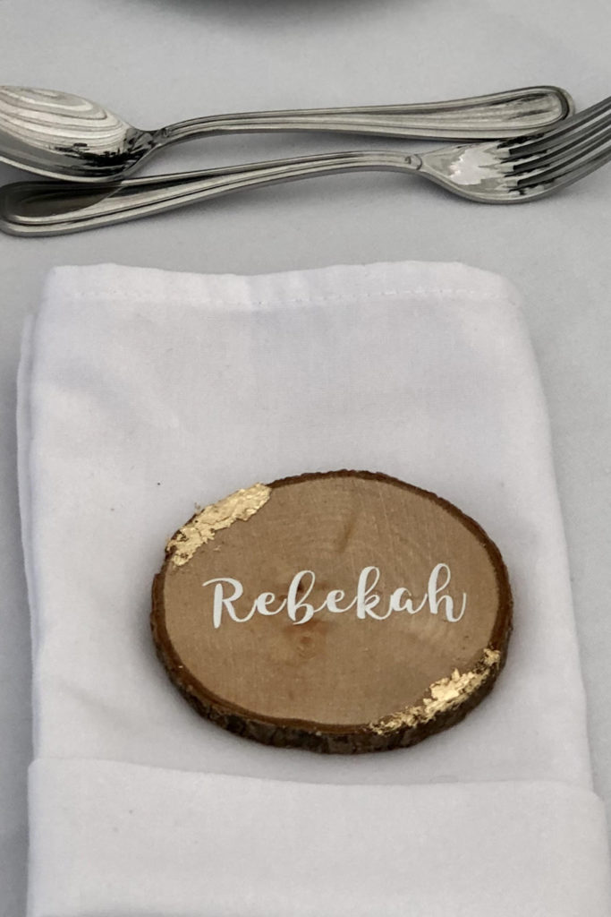 Guest name on wood slice with gold leaf